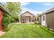 Inviting backyard featuring a well-manicured lawn and covered patio at 3317 Harlan St, Wheat Ridge, CO 80033