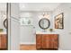 Bathroom boasts marble countertop, wood cabinets, and stylish mirror at 3317 Harlan St, Wheat Ridge, CO 80033