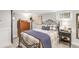 Bedroom with neutral carpeting and decor, featuring a black iron bedframe at 3317 Harlan St, Wheat Ridge, CO 80033