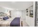 Bedroom with built-in closet and shelving, neutral carpet, and plaid bedding at 3317 Harlan St, Wheat Ridge, CO 80033
