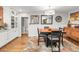 Elegant dining area with a wooden table, built-in glass cabinets, and views into the kitchen, perfect for entertaining at 3317 Harlan St, Wheat Ridge, CO 80033