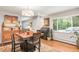 Comfortable dining area featuring warm wood floors and cabinetry, with views into the living room adding convenience and style at 3317 Harlan St, Wheat Ridge, CO 80033