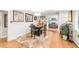 Cozy dining area features a wooden table, wainscoting, and decorative rug at 3317 Harlan St, Wheat Ridge, CO 80033