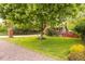 Picture perfect front yard has lush grass and mature trees surrounding this charming home on a quiet street at 3317 Harlan St, Wheat Ridge, CO 80033