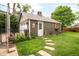 Backyard with a charming, detached garage and stepping stone pathway at 3317 Harlan St, Wheat Ridge, CO 80033