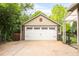 Spacious two car garage with white doors and a driveway at 3317 Harlan St, Wheat Ridge, CO 80033