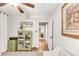 Hallway featuring a green cabinet with glass doors leading to the bedroom at 3317 Harlan St, Wheat Ridge, CO 80033