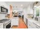 Open kitchen with stainless steel appliances and view to dining and living area at 3317 Harlan St, Wheat Ridge, CO 80033