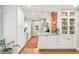 Bright kitchen with white cabinets, quartz countertops, and a brick accent wall at 3317 Harlan St, Wheat Ridge, CO 80033