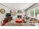 Comfortable living room featuring a fireplace, plush seating, and a large window that lets in ample natural light at 3317 Harlan St, Wheat Ridge, CO 80033