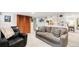 Basement living room with a comfortable gray sofa and decorative built-in shelving at 3317 Harlan St, Wheat Ridge, CO 80033