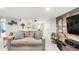 Bright basement living room featuring a gray sofa and wood accent wall at 3317 Harlan St, Wheat Ridge, CO 80033