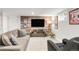 Living room featuring a grey sofa, and media center against a decorative wood accent wall at 3317 Harlan St, Wheat Ridge, CO 80033