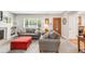Spacious living room showcasing cozy sofas, a decorative fireplace, and a view of the front yard through a large window at 3317 Harlan St, Wheat Ridge, CO 80033