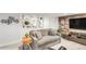 Basement living room featuring built in shelves and a comfy grey sofa at 3317 Harlan St, Wheat Ridge, CO 80033