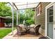 Charming patio featuring comfortable wicker furniture and a well-maintained lawn at 3317 Harlan St, Wheat Ridge, CO 80033
