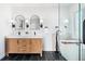 Modern bathroom features a double sink vanity, black fixtures, and a luxurious soaking tub at 2990 S Elm St, Denver, CO 80222