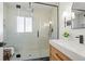 Sleek bathroom featuring glass enclosed shower, rain shower head, and stylish vanity with marble countertop at 2990 S Elm St, Denver, CO 80222