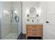 Modern bathroom with glass enclosed shower, stylish vanity with marble countertop, and black hardware at 2990 S Elm St, Denver, CO 80222