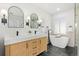 Modern bathroom features a double vanity, soaking tub, and sleek fixtures at 2990 S Elm St, Denver, CO 80222