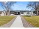 Charming home with a well-manicured front yard, new walkway and exterior paint at 2990 S Elm St, Denver, CO 80222