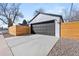 Detached garage features a gray door and wooden fence at 2990 S Elm St, Denver, CO 80222