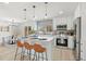 Bright, updated kitchen featuring white cabinetry, stainless appliances, and a dining nook at 2990 S Elm St, Denver, CO 80222