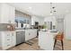 Updated kitchen with white cabinets, stainless steel appliances, and breakfast bar seating at 2990 S Elm St, Denver, CO 80222