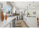Modern kitchen featuring white countertops, stainless appliances, and island with barstools at 2990 S Elm St, Denver, CO 80222