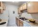 Bright kitchen featuring classic appliances, white cabinets and tile floors at 1130 N Pennsylvania St # 206, Denver, CO 80203