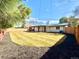 Large backyard featuring a pristine lawn and newer wood fence and covered patio at 1559 S Forest St, Denver, CO 80222