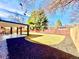 Gorgeous backyard featuring a sprawling lawn, covered patio, and newer wood fence at 1559 S Forest St, Denver, CO 80222