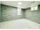 Cozy bedroom in basement featuring stone wall and bright window at 1559 S Forest St, Denver, CO 80222