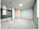 Well-lit basement bedroom with mirrored closet doors and stone accent wall at 1559 S Forest St, Denver, CO 80222