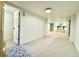 Spacious basement with neutral carpet, white walls, and a doorway to a bedroom at 1559 S Forest St, Denver, CO 80222