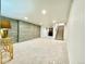 Spacious basement featuring stone accent wall, carpeted floors, and staircase at 1559 S Forest St, Denver, CO 80222