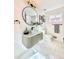Stylish bathroom featuring a modern vanity, round mirror, and elegant marble flooring at 1559 S Forest St, Denver, CO 80222