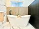 Bright bathroom showing a soaking tub with wood slat accent wall at 1559 S Forest St, Denver, CO 80222