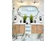 Contemporary bathroom features a double vanity with wood cabinets and marble countertops at 1559 S Forest St, Denver, CO 80222
