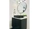 Stylish bathroom featuring a modern vanity, round mirror, and elegant faucet at 1559 S Forest St, Denver, CO 80222