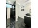 Modern bathroom with dark marble tile shower, floating vanity, and sleek fixtures at 1559 S Forest St, Denver, CO 80222