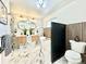 Stunning bathroom featuring double vanity, soaking tub, marble floors and modern fixtures at 1559 S Forest St, Denver, CO 80222