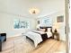 Bright bedroom features hardwood floors, two large windows, and modern decor at 1559 S Forest St, Denver, CO 80222