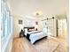 Bright bedroom features hardwood floors, a closet with a sliding door, and large windows at 1559 S Forest St, Denver, CO 80222