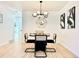 Dining area with modern light fixtures, wall art, a black table, and seating for four at 1559 S Forest St, Denver, CO 80222