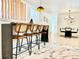 Contemporary dining area with modern light fixtures, a dining table, and hardwood floors at 1559 S Forest St, Denver, CO 80222
