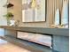 Modern electric fireplace with decorative art and shelving, creating a cozy focal point at 1559 S Forest St, Denver, CO 80222