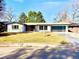 Stylish single-story home with well-manicured lawn, fresh paint, and modern garage door at 1559 S Forest St, Denver, CO 80222