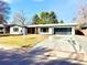 Charming single-story home with well-manicured lawn, fresh paint, and modern garage door at 1559 S Forest St, Denver, CO 80222