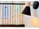 Modern wall sconce illuminating a hallway with railing in neutral tones at 1559 S Forest St, Denver, CO 80222